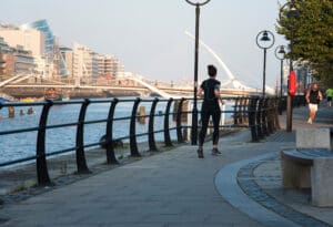 Dublin runner on the quays - morning time. Convention centre in the backgournd