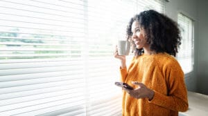 Relocating Renter to Dublin drinks tea happily in new apartment.