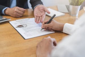 Image of real estage agent and renter signing forms in Dublin Ireland.