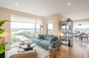 East Wharf Apartments living room with floor-to-ceiling windows and a smart TV